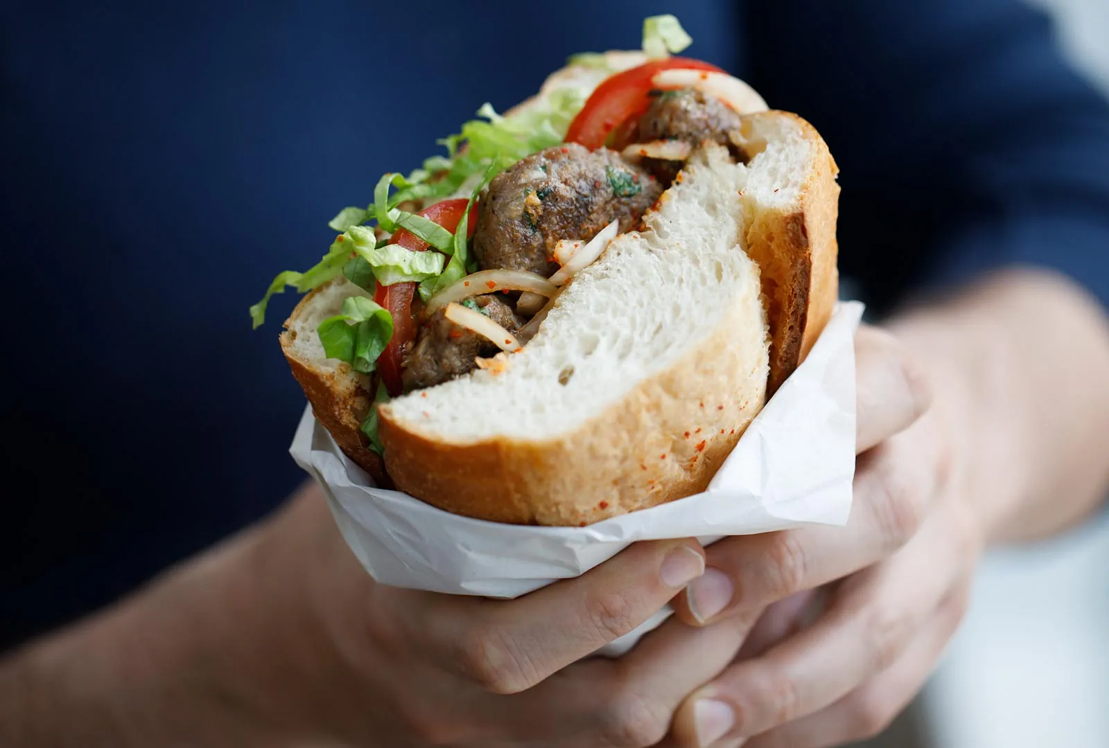 A large sandwich that someone is enjoying